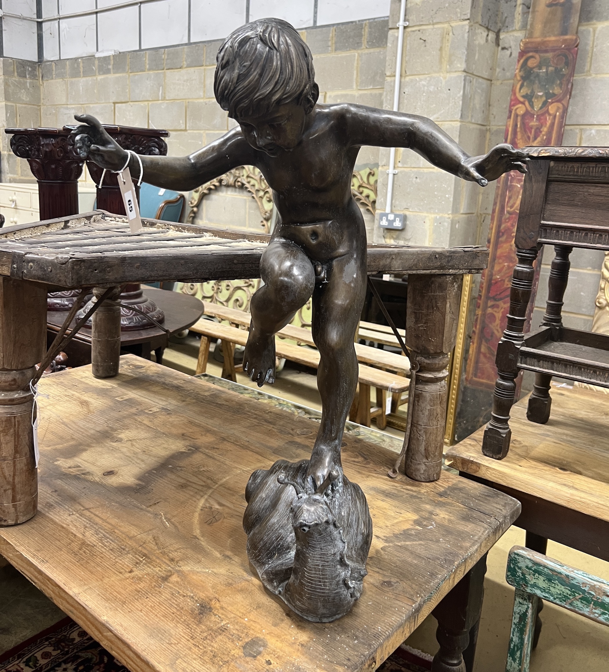 A bronze garden fountain modelled as a boy standing on a snail, height 71cm